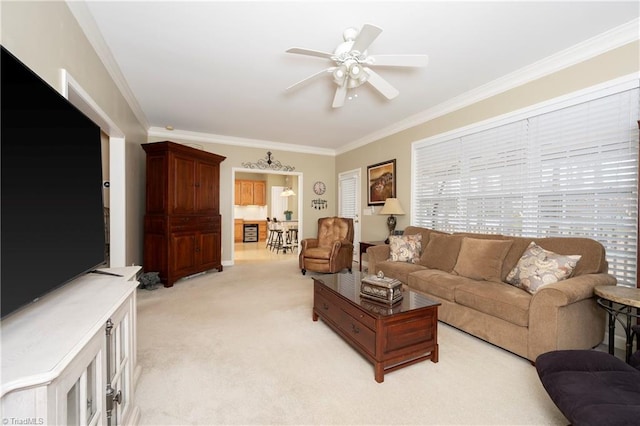 carpeted living room with crown molding and ceiling fan