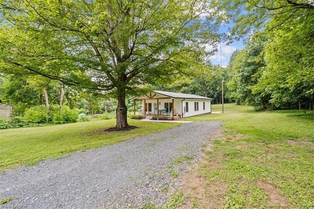 7517 NC Highway 62, Trinity, NC 27370 - view of front of home featuring a front lawn, gravel driveway, and covered porch