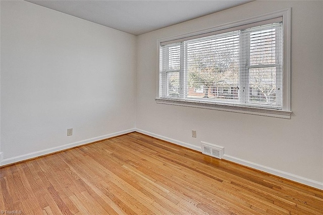 spare room with light hardwood / wood-style floors