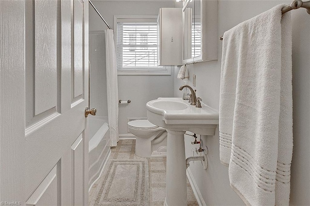 bathroom with shower / bath combo with shower curtain and toilet