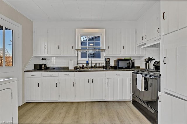 kitchen featuring decorative backsplash, sink, white cabinetry, and black appliances