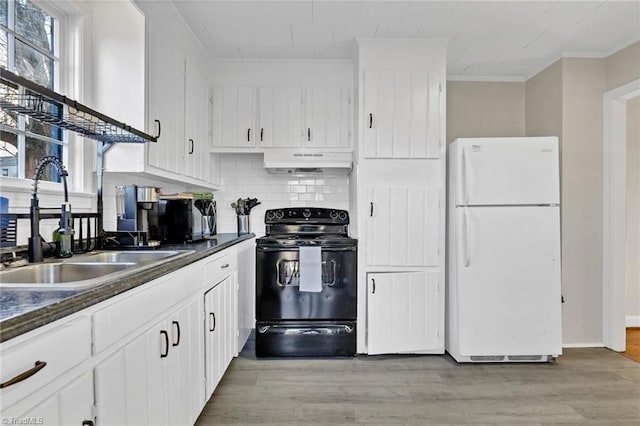 kitchen featuring white cabinetry, white fridge, tasteful backsplash, sink, and black electric range