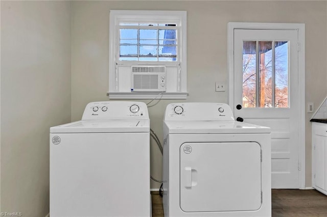 washroom featuring cooling unit, washing machine and dryer, and a healthy amount of sunlight