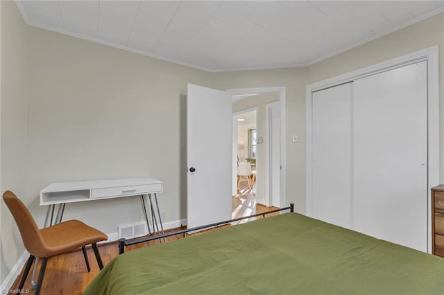 bedroom with a closet and crown molding