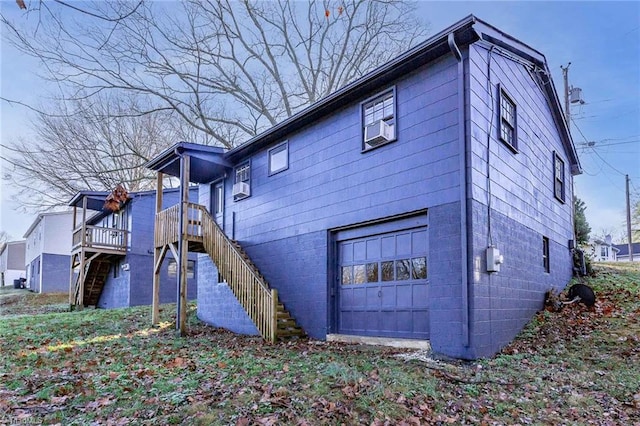 rear view of house with a deck, a garage, and cooling unit