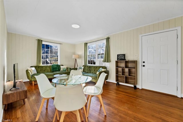 dining room featuring dark wood-type flooring and crown molding