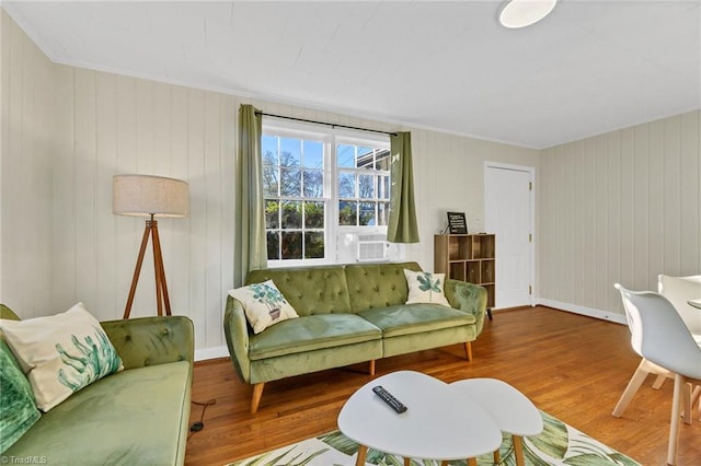 living room with hardwood / wood-style floors and crown molding