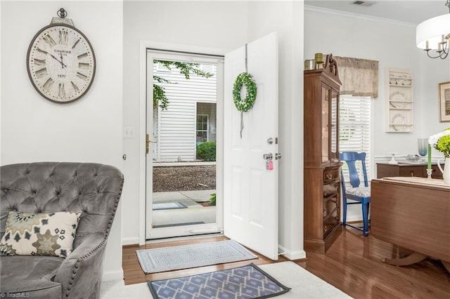 130 W Brick Walk Ct, Mocksville, NC 27028 - entryway with wood finished floors, ornamental molding, and a chandelier