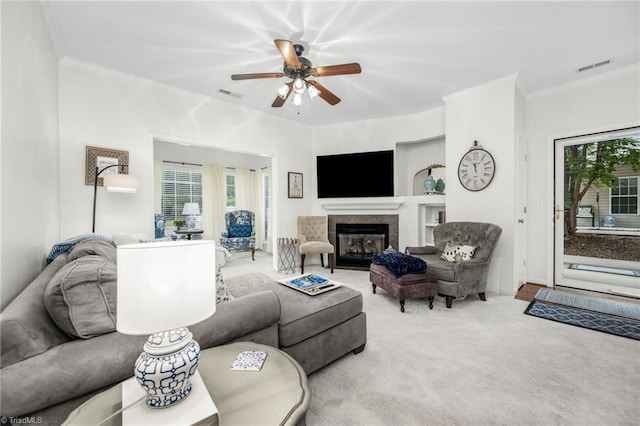130 W Brick Walk Ct, Mocksville, NC 27028 - carpeted living area featuring plenty of natural light, a ceiling fan, built in features, crown molding, and a glass covered fireplace