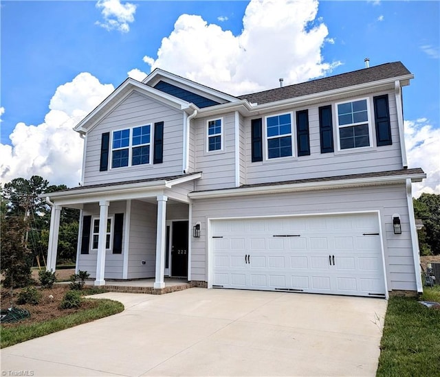 traditional-style home with a garage, driveway, and a porch