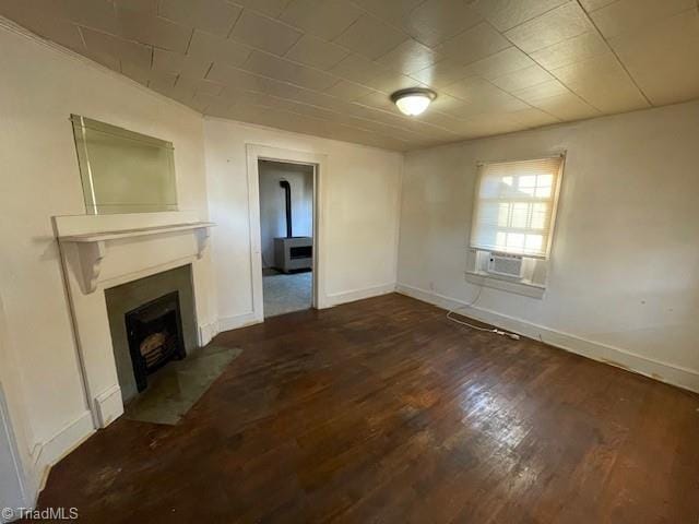 unfurnished living room with cooling unit and dark wood-type flooring