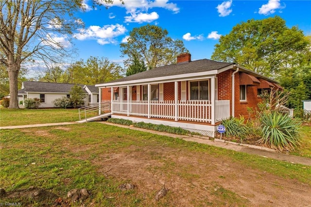 single story home with a porch and a front lawn