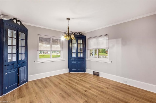 unfurnished dining area with crown molding, light hardwood / wood-style flooring, and a healthy amount of sunlight