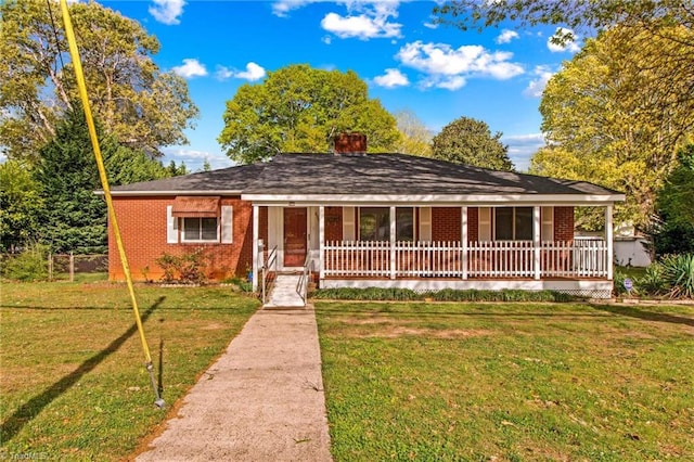 ranch-style home with a front yard and a porch