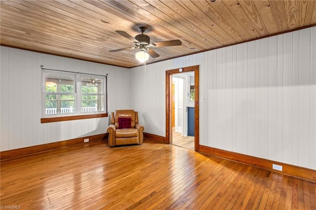 living area with wood walls, light hardwood / wood-style floors, and wooden ceiling