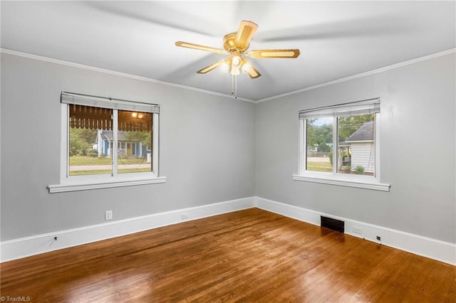 empty room with wood-type flooring, ornamental molding, and ceiling fan