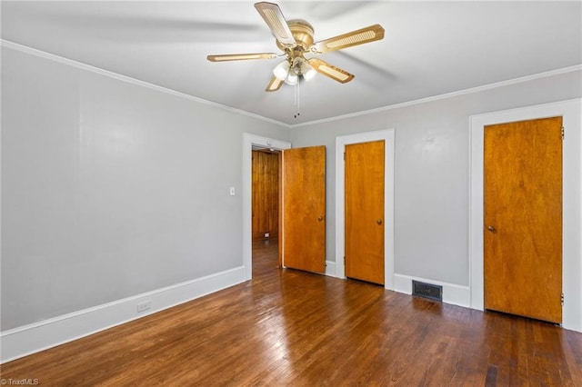 unfurnished bedroom featuring crown molding, ceiling fan, and dark wood-type flooring