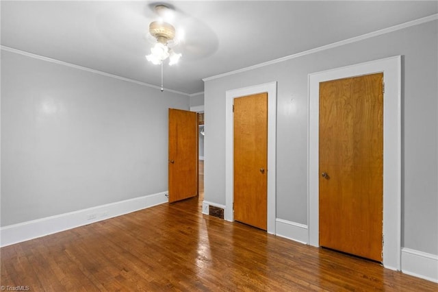 unfurnished bedroom with ornamental molding, hardwood / wood-style flooring, and ceiling fan