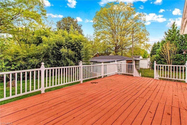 wooden terrace with a storage shed