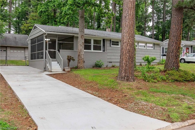 2508 Netherwood Dr, Greensboro, NC 27408 - ranch-style house with a sunroom, driveway, a chimney, crawl space, and brick siding
