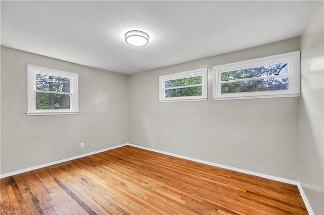 2508 Netherwood Dr, Greensboro, NC 27408 - unfurnished room with baseboards and wood finished floors