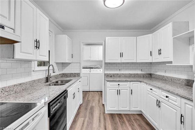 2508 Netherwood Dr, Greensboro, NC 27408 - kitchen with dishwasher, washing machine and clothes dryer, open shelves, light wood-style flooring, and white cabinetry
