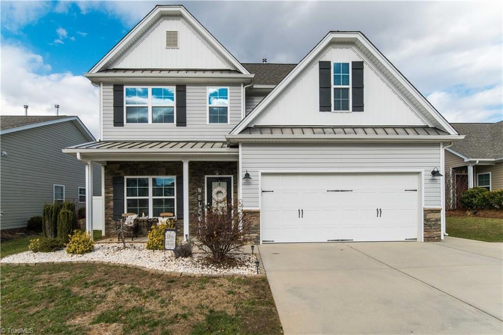 craftsman house with covered porch and a front yard