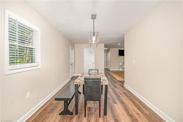 dining space with wood-type flooring