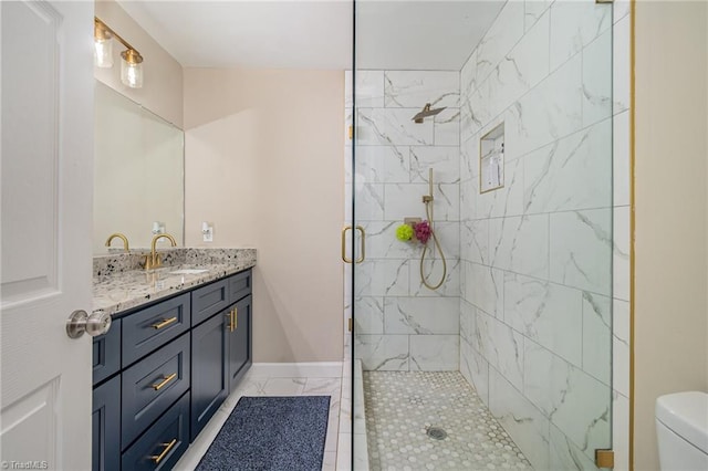 bathroom with vanity, toilet, and a shower with shower door