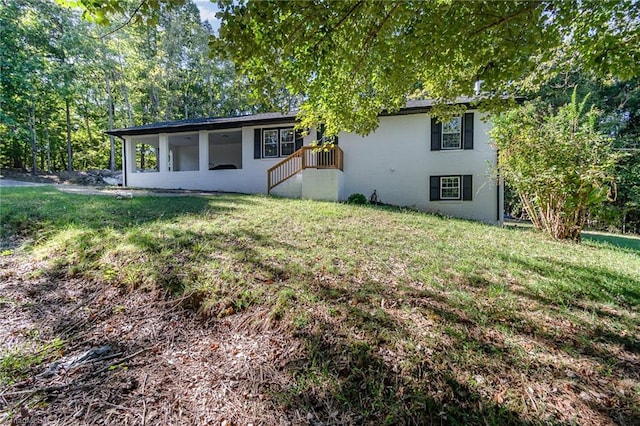 rear view of property with a lawn