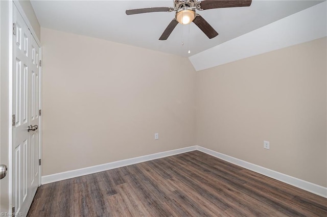 unfurnished room featuring dark hardwood / wood-style floors, vaulted ceiling, and ceiling fan