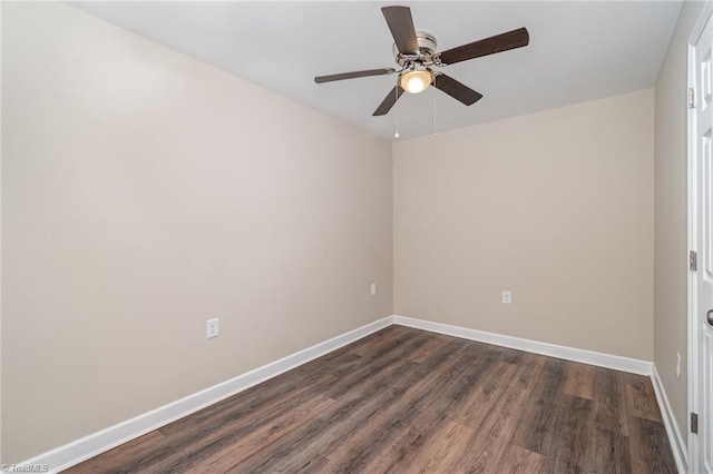 spare room with ceiling fan and dark hardwood / wood-style flooring