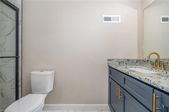 bathroom with tile patterned flooring, a shower with door, vanity, and toilet