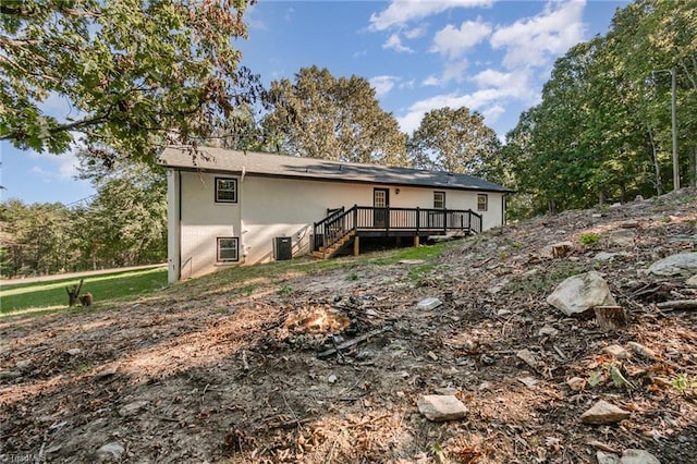 rear view of property with a wooden deck