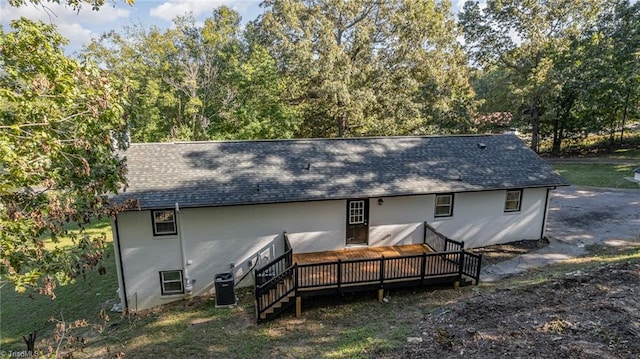 back of house with central AC unit and a wooden deck