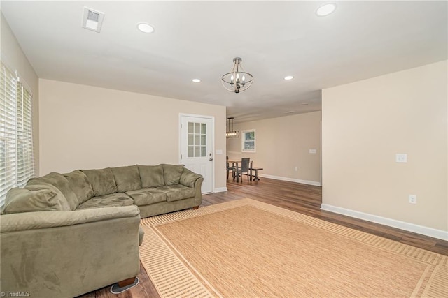 living room featuring hardwood / wood-style floors and a chandelier