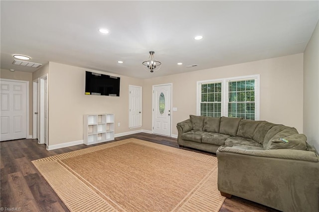 living room with an inviting chandelier and dark hardwood / wood-style floors