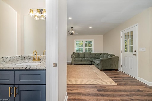 interior space with vanity and wood-type flooring