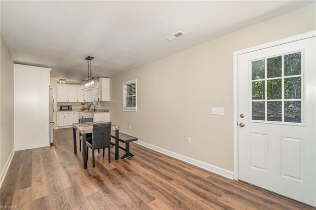 dining room with wood-type flooring and sink