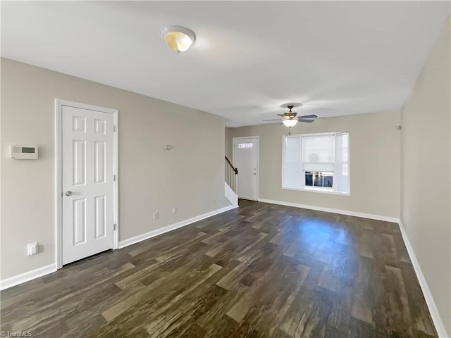 unfurnished living room with ceiling fan and dark hardwood / wood-style flooring