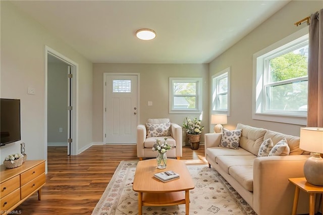 living area with wood finished floors and baseboards