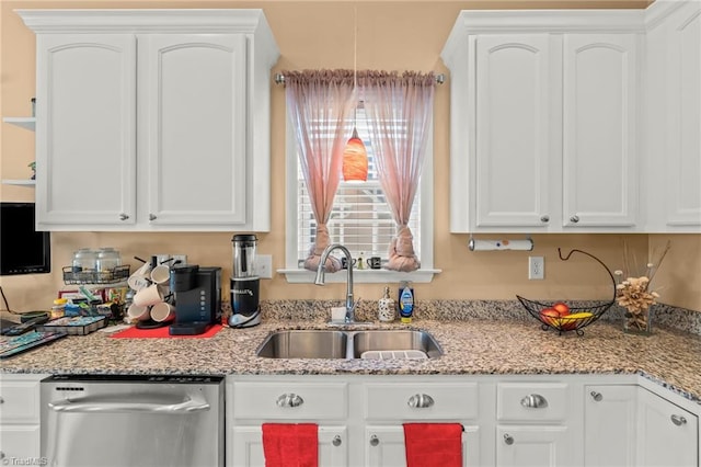 kitchen featuring a sink, light stone counters, dishwasher, and white cabinets