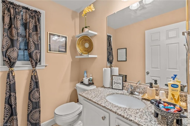 bathroom featuring toilet and vanity