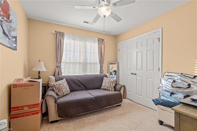 interior space featuring carpet flooring, visible vents, and ceiling fan