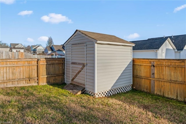 view of shed featuring a residential view and a fenced backyard