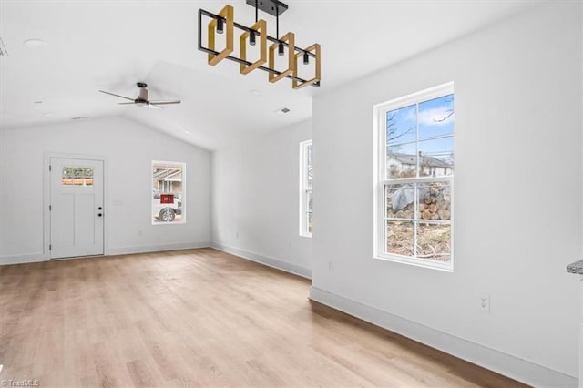 interior space featuring light hardwood / wood-style floors, vaulted ceiling, and ceiling fan