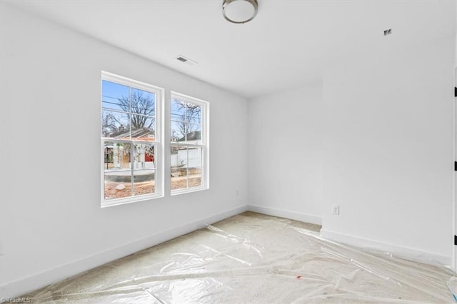 empty room with light colored carpet