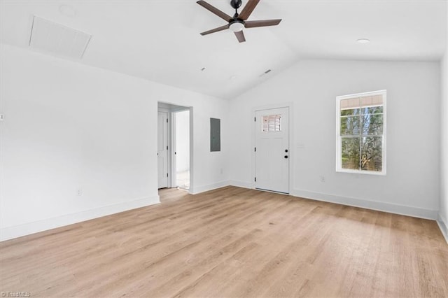 spare room with electric panel, ceiling fan, lofted ceiling, and light wood-type flooring