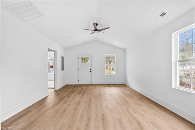 unfurnished living room with light hardwood / wood-style floors, ceiling fan, a healthy amount of sunlight, and lofted ceiling