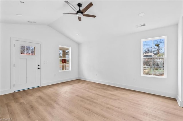 unfurnished living room featuring vaulted ceiling, light hardwood / wood-style flooring, and ceiling fan